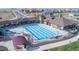 Aerial view of a community pool featuring lounge chairs and umbrellas for relaxing by the pool at 17949 W 94Th Dr, Arvada, CO 80007