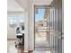 Inviting entryway with decorative security door and view into a bright office space at 17949 W 94Th Dr, Arvada, CO 80007