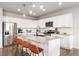 Modern kitchen with stainless steel appliances, granite countertops, and seating at the island at 17949 W 94Th Dr, Arvada, CO 80007