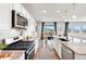 Eat-in kitchen features granite countertops, stainless appliances, and hardwood floors at 17949 W 94Th Dr, Arvada, CO 80007