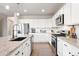 Bright kitchen featuring stainless steel appliances, granite countertops, and an island with seating at 17949 W 94Th Dr, Arvada, CO 80007