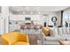 Open-concept kitchen featuring white cabinets, stainless steel appliances, and a large island with seating at 17949 W 94Th Dr, Arvada, CO 80007