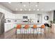 Well-lit kitchen with stainless steel appliances, granite countertops, and seating at the island at 17949 W 94Th Dr, Arvada, CO 80007