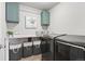 Well-organized laundry room with modern washer and dryer units at 17949 W 94Th Dr, Arvada, CO 80007