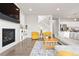 Bright and spacious living room featuring a fireplace, hardwood floors, and staircase at 17949 W 94Th Dr, Arvada, CO 80007