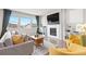 Cozy living room with a fireplace, large windows, and comfortable seating arrangement at 17949 W 94Th Dr, Arvada, CO 80007