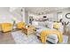 Open floor plan combining the living room with view into kitchen, staircase, and dining area at 17949 W 94Th Dr, Arvada, CO 80007