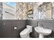 Stylish powder room features modern fixtures, elegant wallpaper, and wainscoting at 17949 W 94Th Dr, Arvada, CO 80007