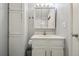 Bright bathroom with white vanity, cabinet, and a tri-fold mirror at 857 S Van Gordon Ct # B107, Lakewood, CO 80228