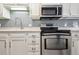 Stainless steel oven and microwave above the range highlight the updated kitchen space at 857 S Van Gordon Ct # B107, Lakewood, CO 80228