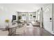 Bright living room with hardwood floors, neutral furniture, and sunlit windows dressed in flowing white drapes at 857 S Van Gordon Ct # B107, Lakewood, CO 80228