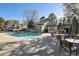 Beautiful outdoor pool with furniture, landscaping, and umbrellas for community use at 857 S Van Gordon Ct # B107, Lakewood, CO 80228