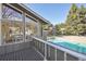 A view from a building's porch overlooking the sparkling pool and green trees at 857 S Van Gordon Ct # B107, Lakewood, CO 80228