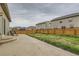 Spacious backyard with a concrete patio, lawn, and wooden fence, ideal for outdoor entertaining at 1888 Ruby Ct, Brighton, CO 80603