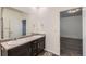 Bathroom featuring a dual sink vanity with an enclosed glass shower and tile floor at 1888 Ruby Ct, Brighton, CO 80603
