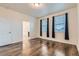 Bright bedroom with hardwood floors, natural light from the windows, and neutral walls at 1888 Ruby Ct, Brighton, CO 80603