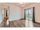 Bright dining area with hardwood floors, chandelier, and sliding glass doors to the backyard at 1888 Ruby Ct, Brighton, CO 80603