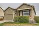 Charming single-Gathering home features a manicured front yard and an attached two-car garage at 1888 Ruby Ct, Brighton, CO 80603