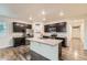 Modern kitchen featuring stainless steel appliances, a center island, and dark wood cabinetry at 1888 Ruby Ct, Brighton, CO 80603