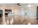 Bright open-concept living area with hardwood floors, a ceiling fan, and neutral paint tones at 1888 Ruby Ct, Brighton, CO 80603