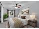 Cozy bedroom with neutral tones, a ceiling fan, a large window, and carpeted floors at 4400 S Quebec St # 207L, Denver, CO 80237