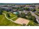 Aerial view of a community featuring a volleyball court, pool, walking trails, and well-maintained green spaces at 17346 Nature Walk Trl # 108, Parker, CO 80134
