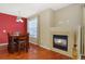 A dining room with a fireplace, wood floors, and a table at 17346 Nature Walk Trl # 108, Parker, CO 80134