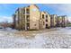 Apartment building with private balconies and stone accents in a well-maintained residential area at 17346 Nature Walk Trl # 108, Parker, CO 80134