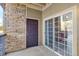 Private patio with sliding glass doors and brick wall at 17346 Nature Walk Trl # 108, Parker, CO 80134