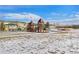 Community playground with modern play structures, picnic area, and snow-covered surroundings at 17346 Nature Walk Trl # 108, Parker, CO 80134