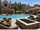 Resort-style pool area with lounge chairs, fire pit, and mature trees offers outdoor relaxation at 17346 Nature Walk Trl # 108, Parker, CO 80134