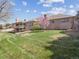 Brick home exterior with manicured lawn and landscaping at 2653 S Harrington Ln, Lakewood, CO 80227