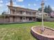 Brick home exterior featuring a large, covered back porch and manicured lawn at 2653 S Harrington Ln, Lakewood, CO 80227
