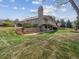 Expansive backyard featuring lush lawn, brick patios and garden areas at 2653 S Harrington Ln, Lakewood, CO 80227
