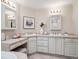 Bright bathroom featuring a dual vanity with a makeup area and stone countertops at 2653 S Harrington Ln, Lakewood, CO 80227
