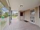 Outdoor deck space featuring a brick nook with storage, railing and a treelined view at 2653 S Harrington Ln, Lakewood, CO 80227