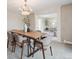 Cozy dining room with modern chandelier, neutral decor, and view into the living room at 2653 S Harrington Ln, Lakewood, CO 80227
