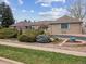 Lovely single story brick home with manicured front yard and mature landscaping at 2653 S Harrington Ln, Lakewood, CO 80227