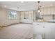 Spacious living room featuring built-in cabinets and a kitchen at 2653 S Harrington Ln, Lakewood, CO 80227