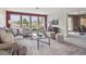 Bright and airy living room with large windows, stylish seating, and vibrant accent wall at 2653 S Harrington Ln, Lakewood, CO 80227