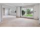 Spacious living room with neutral carpet, bright windows and sliding door access to the outdoor space at 2653 S Harrington Ln, Lakewood, CO 80227