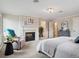 Bright bedroom featuring a fireplace, and access to an ensuite bathroom at 2653 S Harrington Ln, Lakewood, CO 80227