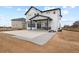 Spacious backyard with a concrete patio, landscaping gravel, and an open view at 16002 E 111Th Cir, Commerce City, CO 80022