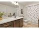 Modern bathroom with a spacious countertop, dark wood cabinets, and stylish fixtures at 16002 E 111Th Cir, Commerce City, CO 80022