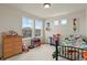 Bright bedroom featuring large windows and cheerful dinosaur-themed decor at 16002 E 111Th Cir, Commerce City, CO 80022