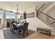 Modern dining room with a hardwood floor, designer rug, and stairway access at 16002 E 111Th Cir, Commerce City, CO 80022