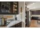 Modern kitchen featuring stainless appliances, granite counters, and custom cabinetry at 16002 E 111Th Cir, Commerce City, CO 80022