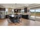 Beautiful kitchen featuring stainless steel appliances, an island with bar seating, and hardwood floors at 16002 E 111Th Cir, Commerce City, CO 80022