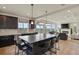 Modern kitchen featuring hardwood floors, island with bar seating, and an open layout at 16002 E 111Th Cir, Commerce City, CO 80022