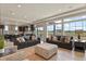 Spacious open-concept living room with hardwood floors, abundant seating, and a sun-filled atmosphere at 16002 E 111Th Cir, Commerce City, CO 80022